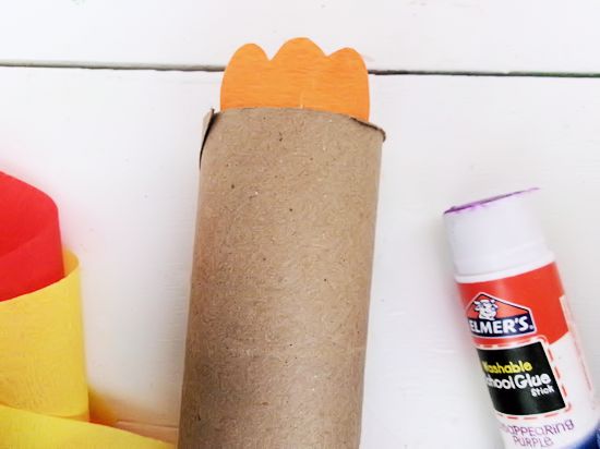 Glue a tuft of feathers to top of roll.