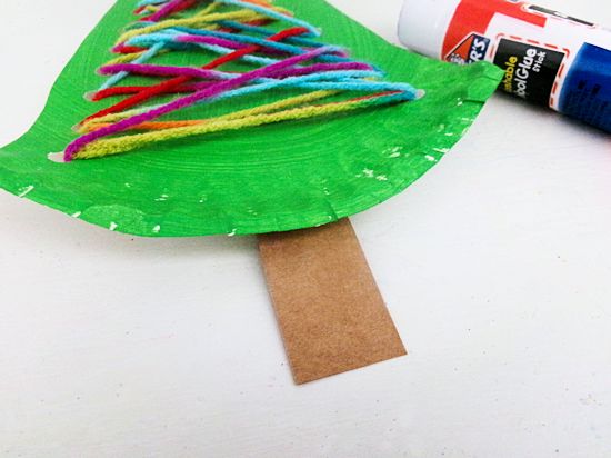 Glue brown strip to bottom of tree for trunk.